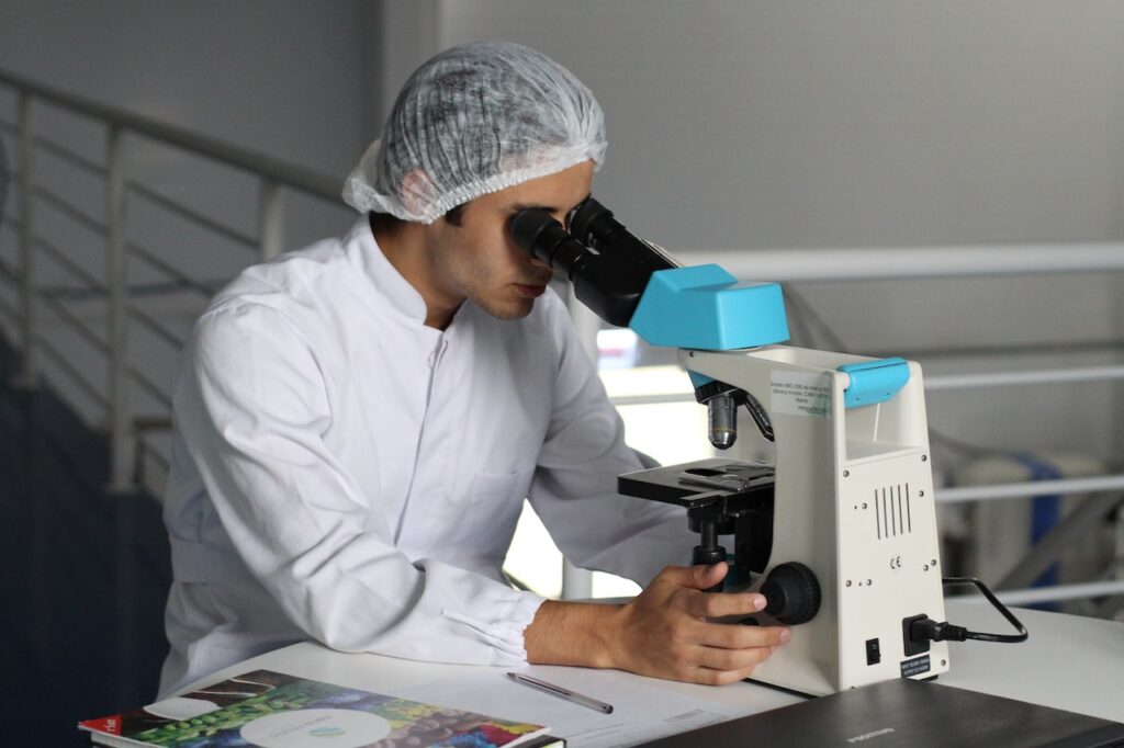 Researcher looking through a microscope